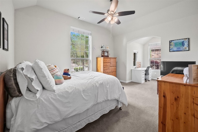 17214 Sequoia Kings Dr, Humble, TX 77346 - bedroom with arched walkways, light carpet, vaulted ceiling, a ceiling fan, and a desk