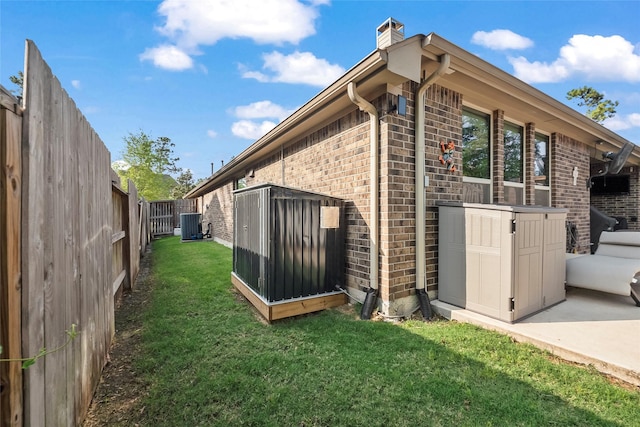 17214 Sequoia Kings Dr, Humble, TX 77346 - view of side of property with brick siding, a chimney, and central air condition unit