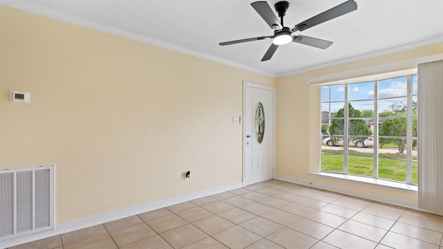 unfurnished room featuring ornamental molding, healthy amount of natural light, light tile patterned floors, and a ceiling fan
