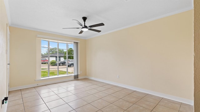 empty room featuring ornamental molding, a ceiling fan, light tile patterned floors, and baseboards