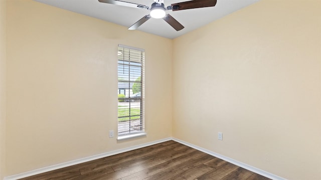 spare room featuring dark wood-style flooring, baseboards, and ceiling fan