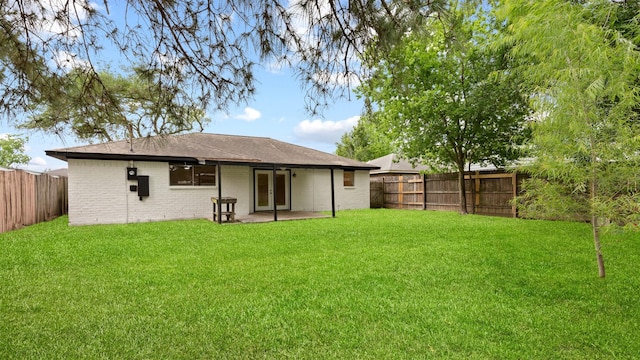 back of house with french doors, a patio, and brick siding