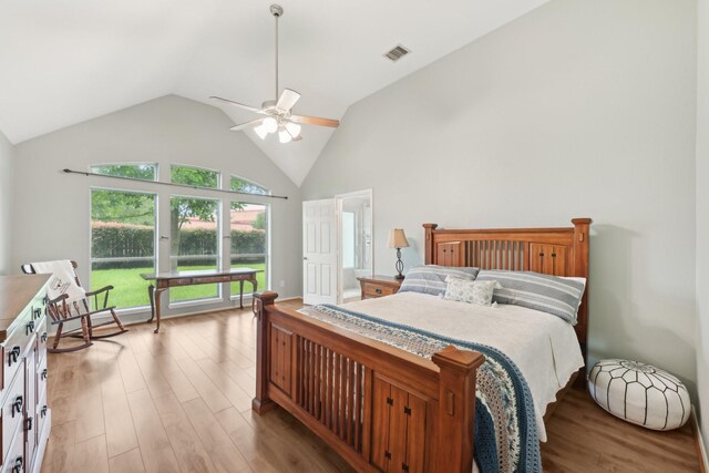 bedroom featuring light wood finished floors, high vaulted ceiling, and ceiling fan