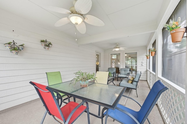 sunroom / solarium with ceiling fan, outdoor dining space, and beam ceiling