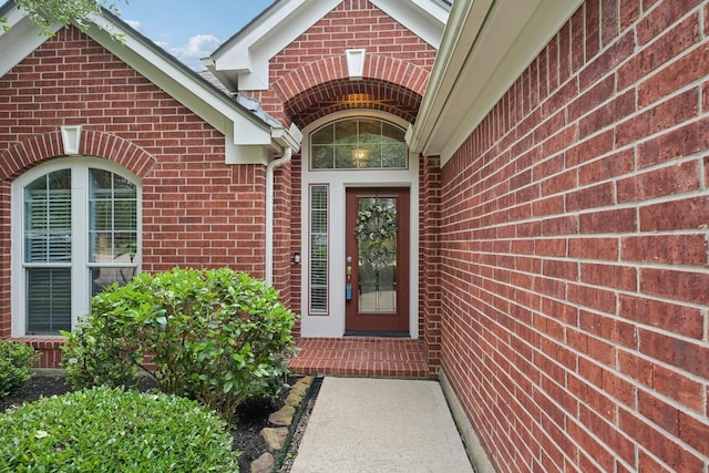 doorway to property with brick siding