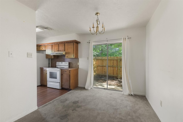 217 Lazy Ln, Conroe, TX 77301 - kitchen featuring white electric range, brown cabinets, dark colored carpet, and a chandelier