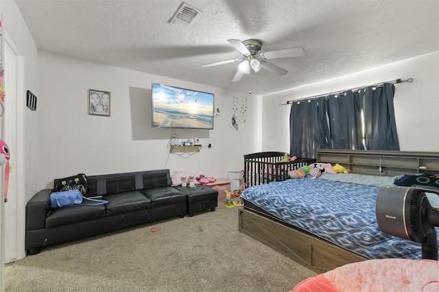 217 Lazy Ln, Conroe, TX 77301 - carpeted bedroom with a textured ceiling and ceiling fan