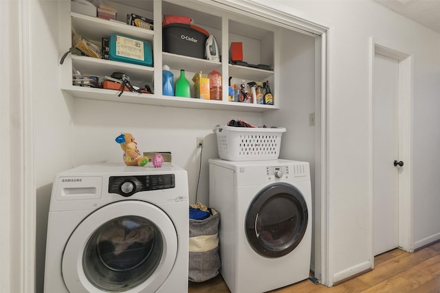 217 Lazy Ln, Conroe, TX 77301 - laundry area with independent washer and dryer and light wood-style flooring