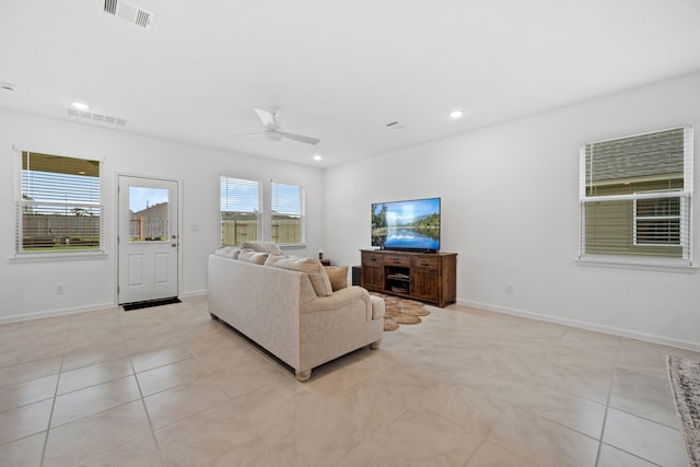 living room with a ceiling fan, light tile patterned floors, baseboards, and recessed lighting