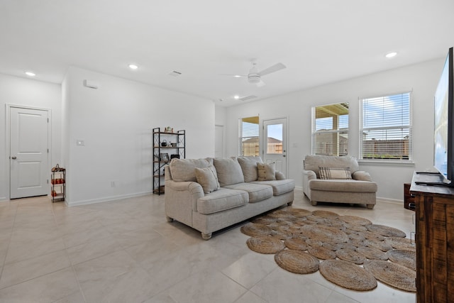 living room with a ceiling fan, recessed lighting, light tile patterned floors, and baseboards