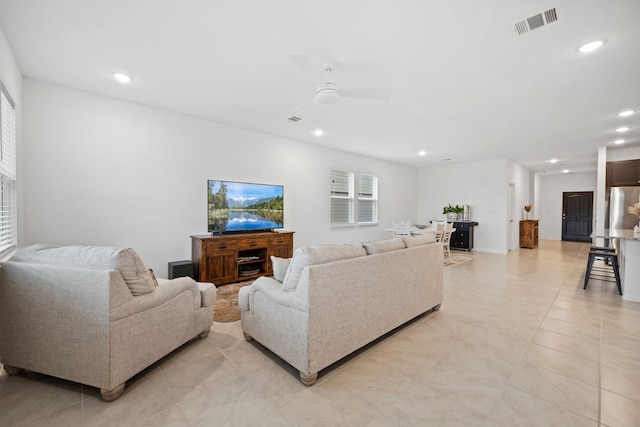 living room with a ceiling fan, recessed lighting, and light tile patterned floors