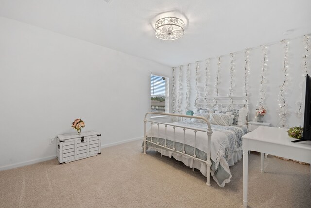 carpeted bedroom featuring baseboards
