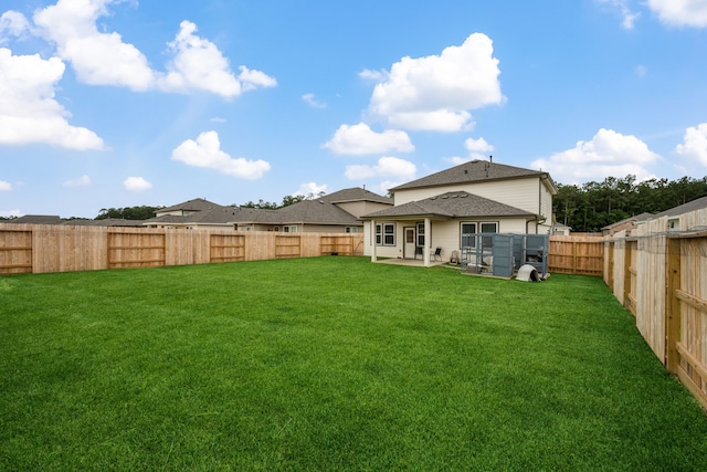 back of house featuring a patio area and roof with shingles