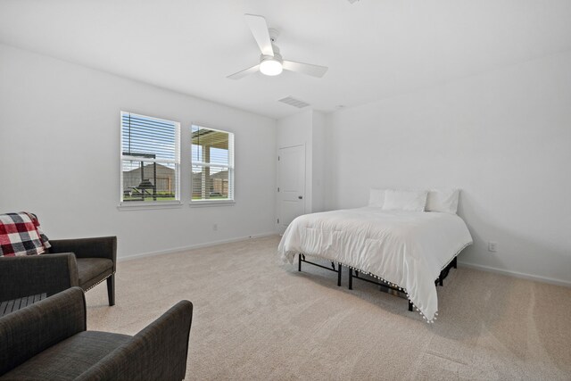 carpeted bedroom featuring baseboards and a ceiling fan