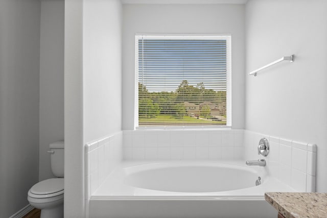 bathroom featuring a bath and toilet