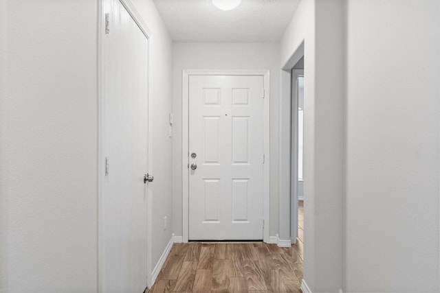 entryway featuring wood finished floors and baseboards