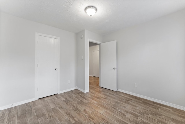 unfurnished bedroom featuring light wood finished floors and baseboards
