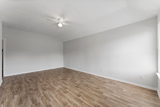 unfurnished room with ceiling fan, light wood-type flooring, lofted ceiling, and baseboards