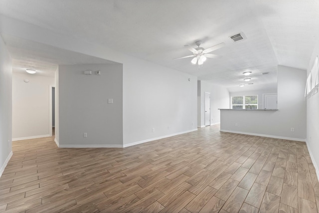 unfurnished living room with light wood-style floors, ceiling fan, and baseboards