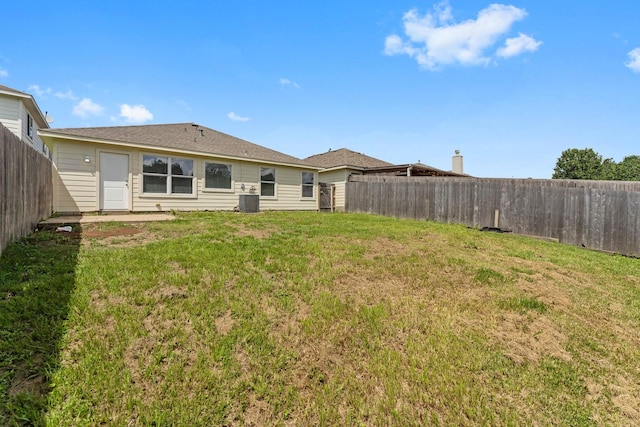 rear view of property with central AC