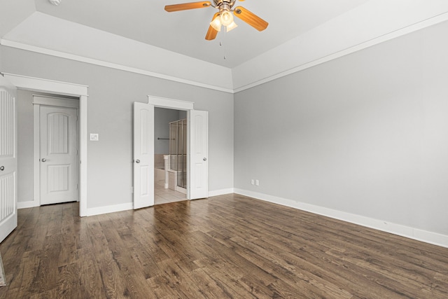 unfurnished bedroom with wood finished floors, baseboards, ensuite bath, and ceiling fan