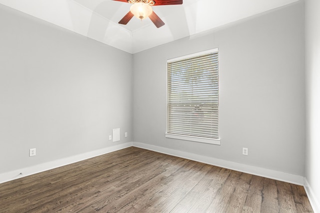 unfurnished room with ceiling fan, wood finished floors, baseboards, and vaulted ceiling