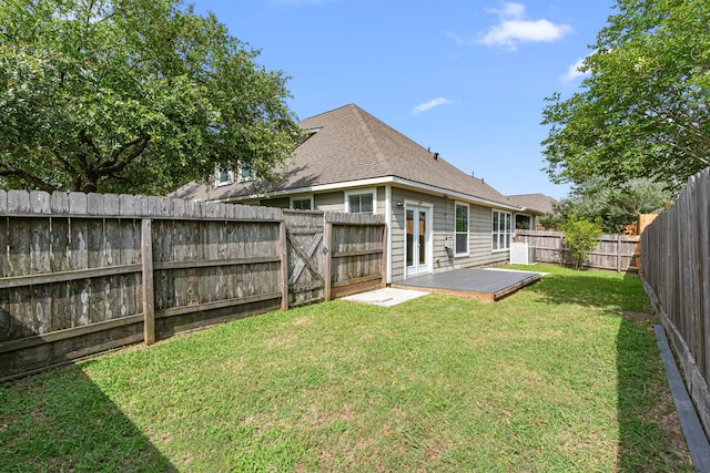 back of property featuring a wooden deck and roof with shingles