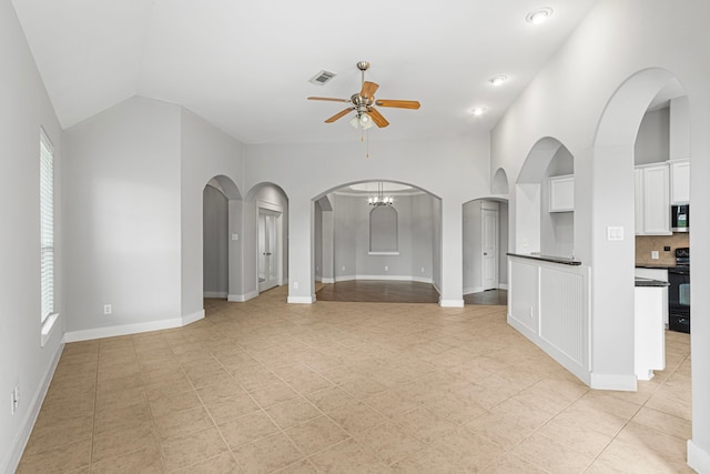 unfurnished living room featuring ceiling fan, vaulted ceiling, light tile patterned floors, arched walkways, and baseboards