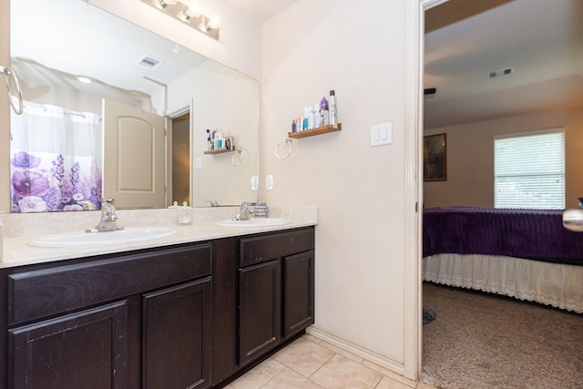 full bathroom with ensuite bath, tile patterned flooring, and double vanity