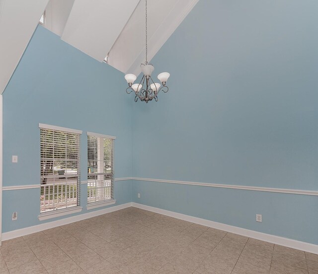 unfurnished room with high vaulted ceiling, a chandelier, and baseboards