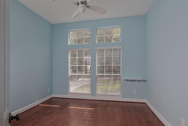 empty room with wood-type flooring, ceiling fan, and baseboards
