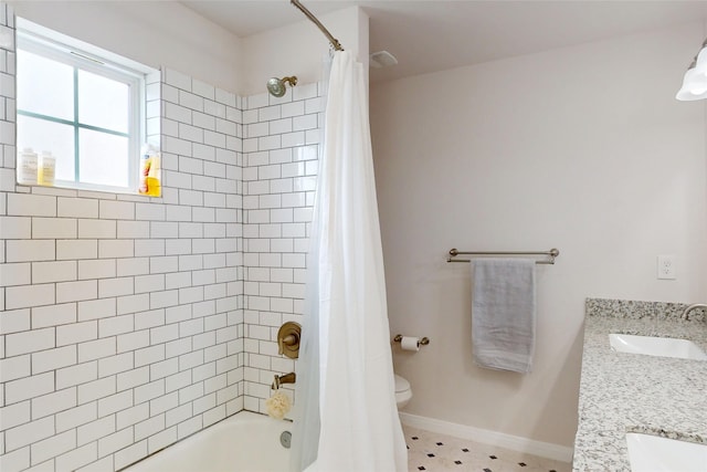 full bathroom featuring shower / bathtub combination with curtain, toilet, double vanity, and baseboards