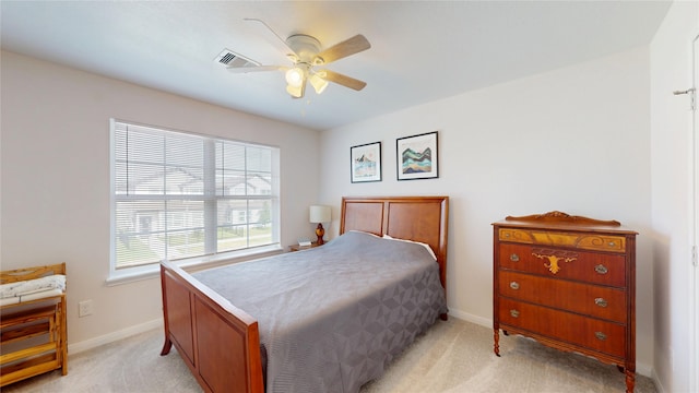 bedroom featuring light colored carpet, baseboards, and a ceiling fan