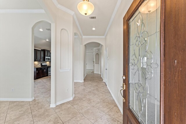 2043 Plum Rose Ln, Richmond, TX 77469 - entrance foyer with arched walkways, ornamental molding, light tile patterned floors, and baseboards