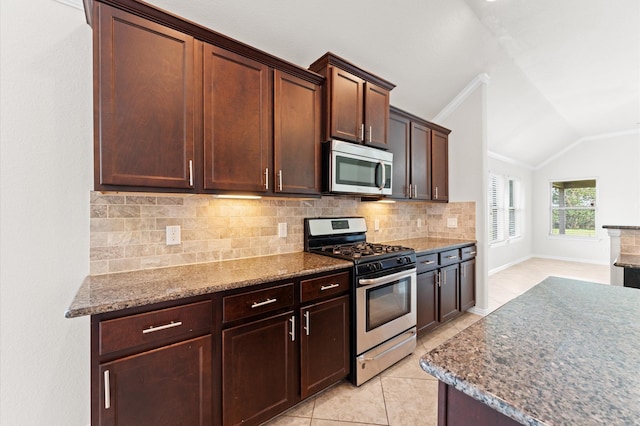 2043 Plum Rose Ln, Richmond, TX 77469 - kitchen with stainless steel appliances, backsplash, vaulted ceiling, light tile patterned floors, and stone counters