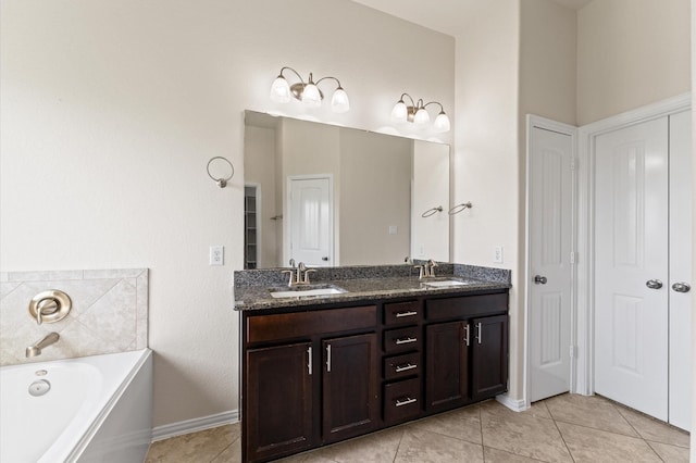 2043 Plum Rose Ln, Richmond, TX 77469 - full bath featuring tile patterned floors, a bath, double vanity, baseboards, and a closet