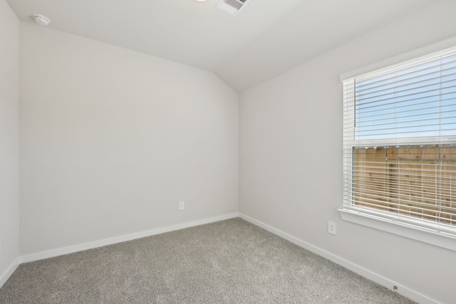 unfurnished room with carpet, a smoke detector, baseboards, and lofted ceiling