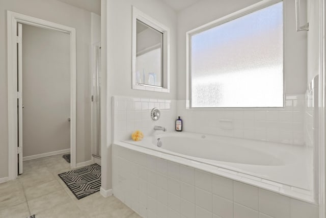 full bathroom featuring a garden tub, tile patterned flooring, a shower, and baseboards