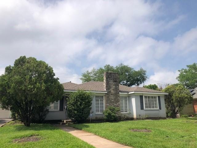 single story home featuring a front lawn and a chimney