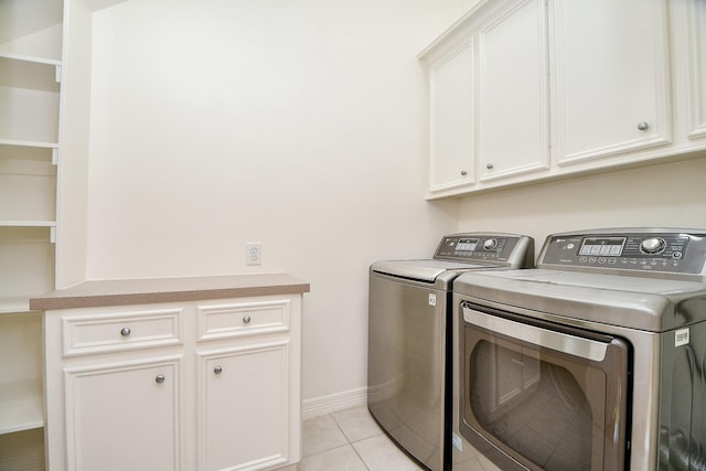 718 Roy St, Houston, TX 77007 - washroom with cabinet space, washing machine and dryer, light tile patterned floors, and baseboards