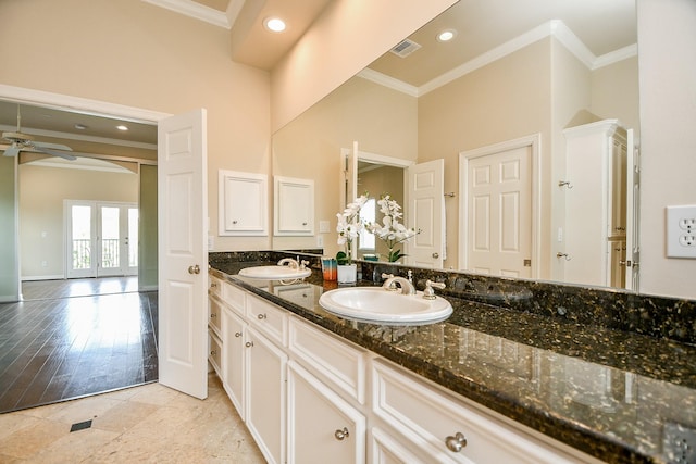 718 Roy St, Houston, TX 77007 - bathroom featuring double vanity, crown molding, a ceiling fan, and a sink