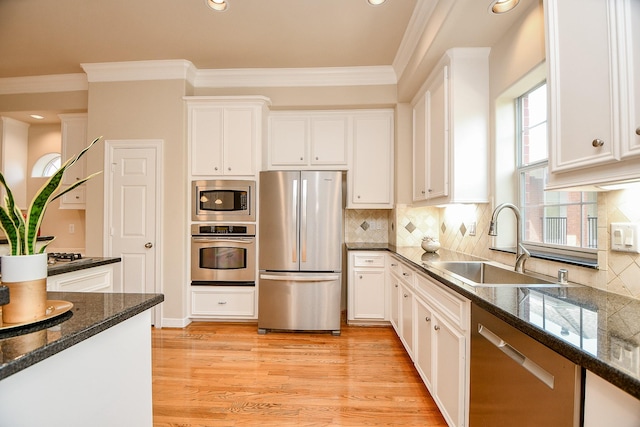 718 Roy St, Houston, TX 77007 - kitchen with a sink, crown molding, stainless steel appliances, and white cabinets