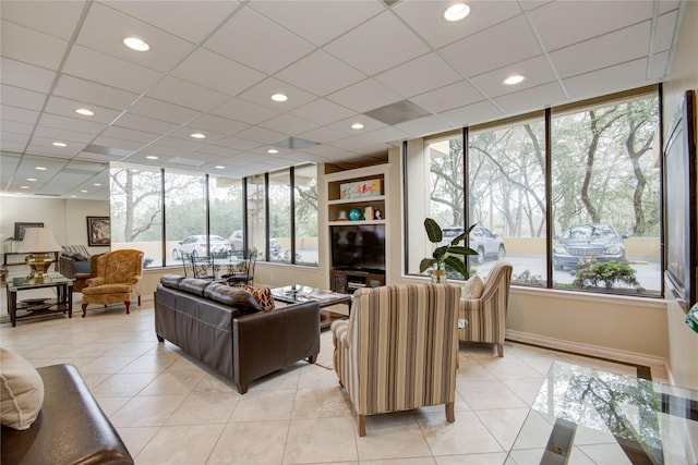 living area featuring light tile patterned flooring, recessed lighting, and baseboards