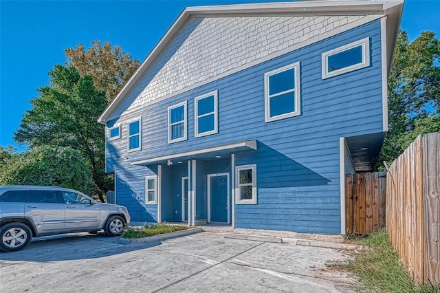 view of front of home featuring fence