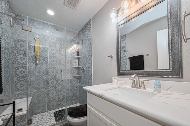 19942 Mountain Dale Dr, Cypress, TX 77433 - bathroom with toilet, vanity, a stall shower, a textured ceiling, and recessed lighting