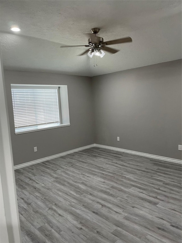 19942 Mountain Dale Dr, Cypress, TX 77433 - unfurnished room featuring ceiling fan, wood finished floors, baseboards, a textured ceiling, and recessed lighting