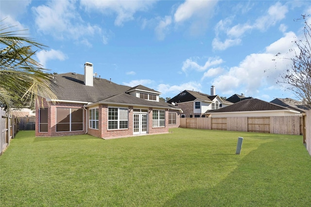 6334 Goodlowe Park, Sugar Land, TX 77479 - rear view of house featuring brick siding, a chimney, and french doors