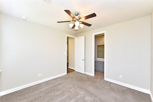 5502 Camaguey St, Houston, TX 77023 - unfurnished bedroom featuring carpet, baseboards, a ceiling fan, and ensuite bathroom