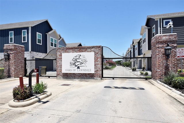 5502 Camaguey St, Houston, TX 77023 - view of concrete road featuring curbs, a gate, and a gated entry