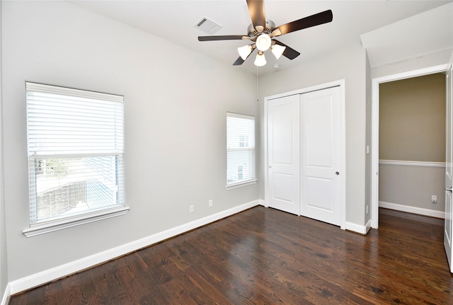 5502 Camaguey St, Houston, TX 77023 - unfurnished bedroom with dark wood-style flooring, a closet, baseboards, and a ceiling fan